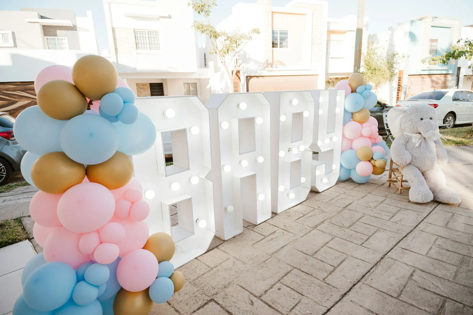 BABY sign with balloons and a teddy bear