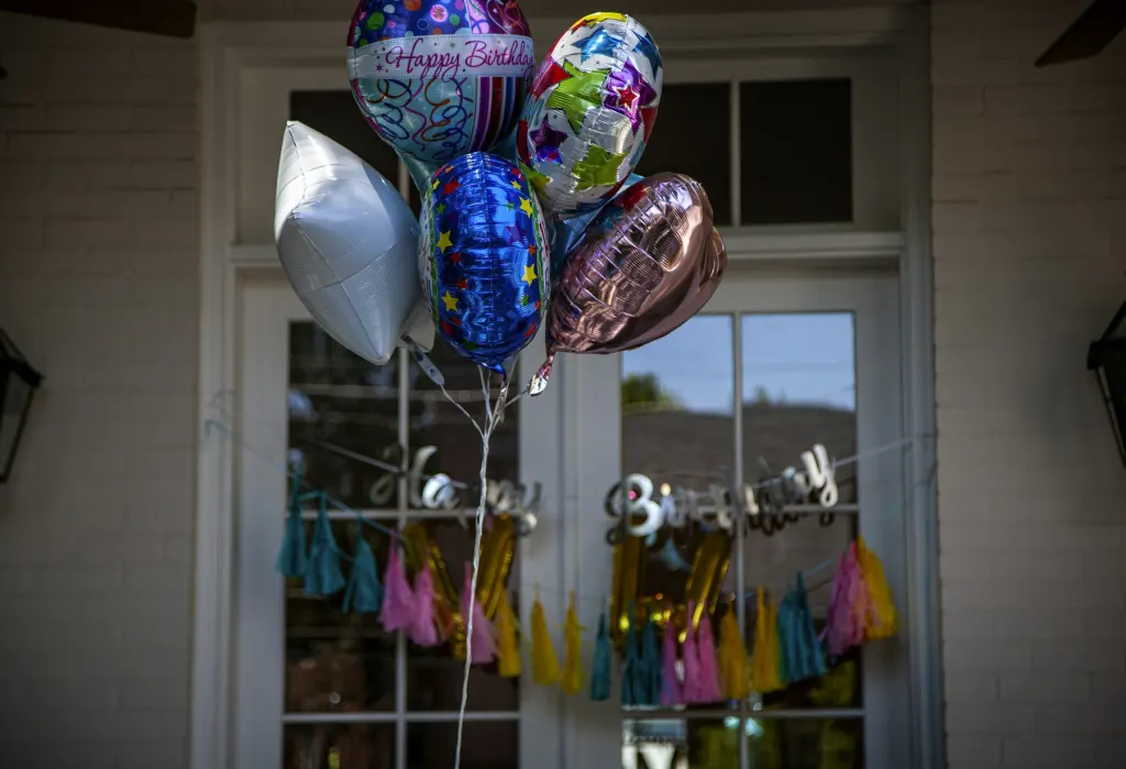 Colourful balloons hanging on ribbons